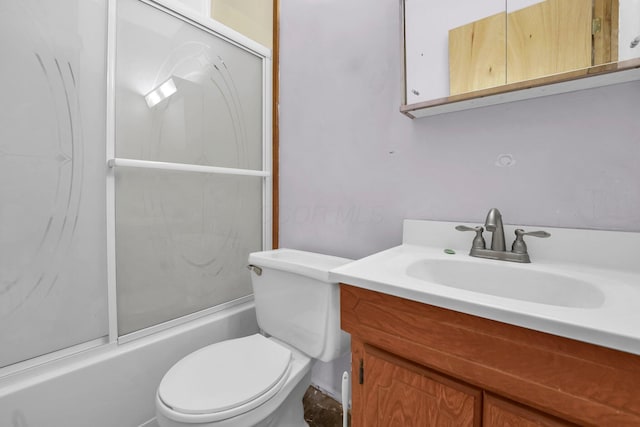 bathroom with bath / shower combo with glass door, vanity, and toilet