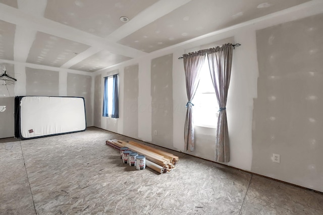 unfurnished room featuring coffered ceiling