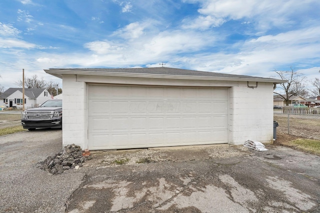 detached garage featuring fence