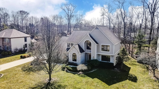 view of front of house with stone siding and a front yard