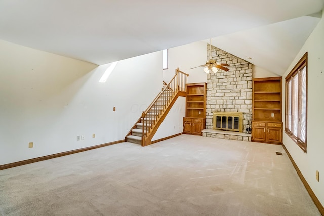 unfurnished living room featuring stairway, baseboards, carpet floors, a fireplace, and vaulted ceiling