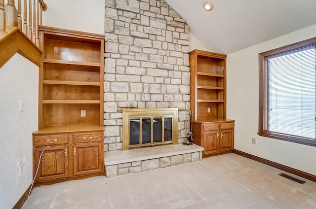 unfurnished living room featuring carpet, visible vents, baseboards, lofted ceiling, and a fireplace