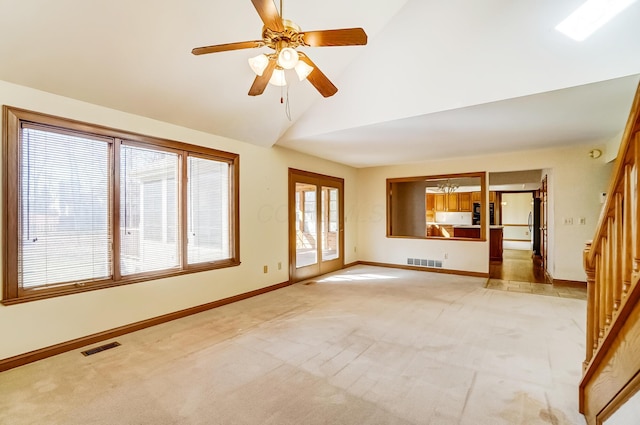 empty room with light carpet, visible vents, stairway, and baseboards