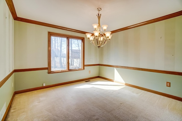 spare room with a notable chandelier, carpet flooring, baseboards, and visible vents