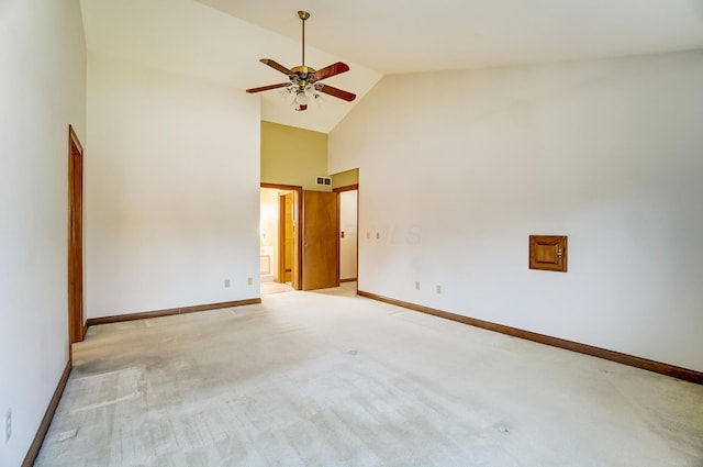 unfurnished room featuring visible vents, light carpet, high vaulted ceiling, a ceiling fan, and baseboards