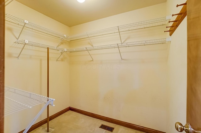 spacious closet featuring visible vents