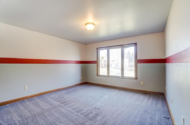 spare room with baseboards, carpet floors, and visible vents