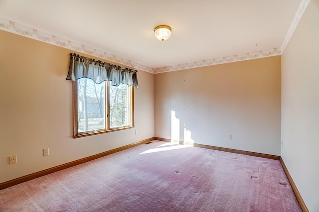 carpeted empty room with baseboards