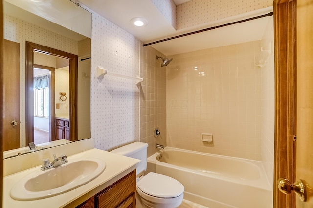 full bath featuring toilet, vanity, wallpapered walls, and shower / bathing tub combination