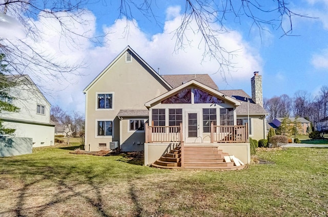 back of house featuring stairway, a lawn, a chimney, and a sunroom