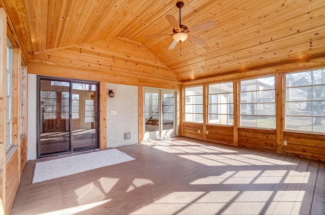 unfurnished sunroom with a ceiling fan, vaulted ceiling, and wood ceiling