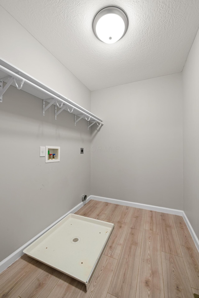 washroom with laundry area, hookup for a washing machine, electric dryer hookup, and light wood-style floors