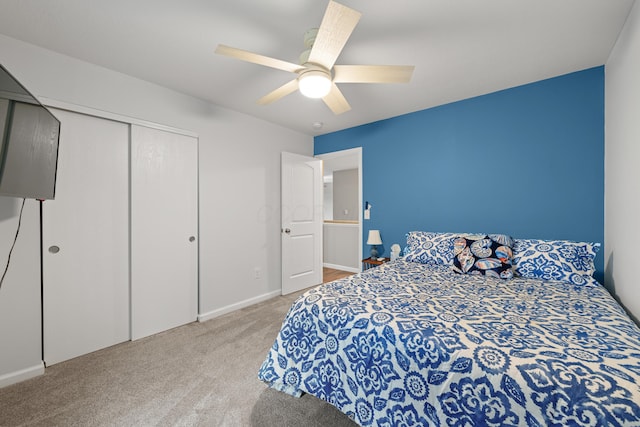 carpeted bedroom featuring a closet, a ceiling fan, and baseboards