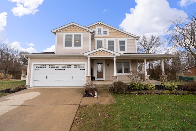 view of front facade with a porch, a garage, driveway, and a front lawn