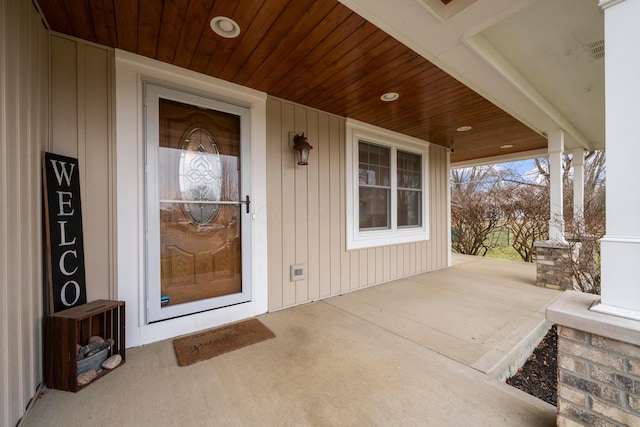 entrance to property featuring covered porch and visible vents