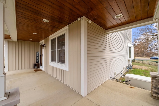 exterior space featuring covered porch and fence