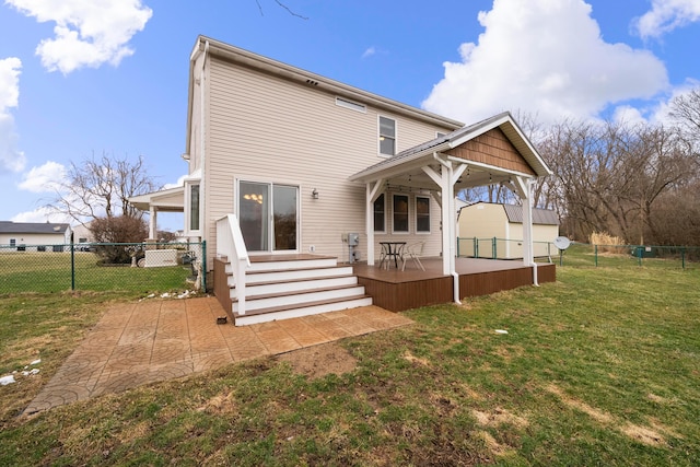 rear view of property with a fenced backyard, a lawn, and a patio