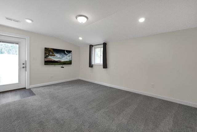 unfurnished room featuring recessed lighting, visible vents, dark carpet, vaulted ceiling, and baseboards