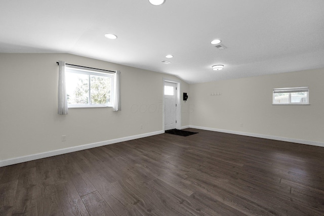 unfurnished room featuring dark wood-type flooring, recessed lighting, vaulted ceiling, and baseboards