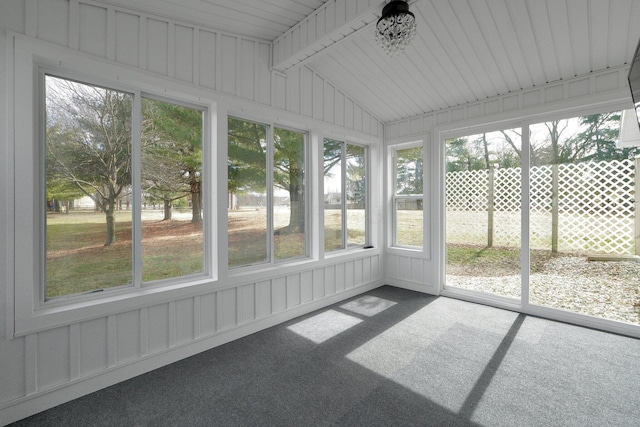 unfurnished sunroom featuring vaulted ceiling with beams