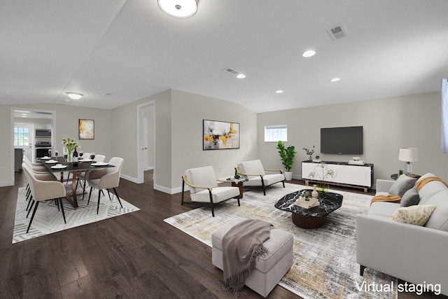 living room with baseboards, visible vents, wood finished floors, and recessed lighting