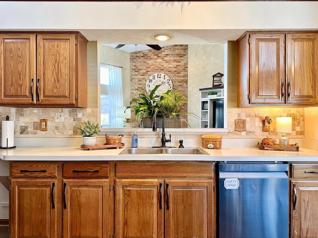 kitchen with tasteful backsplash, light countertops, dishwasher, and a sink