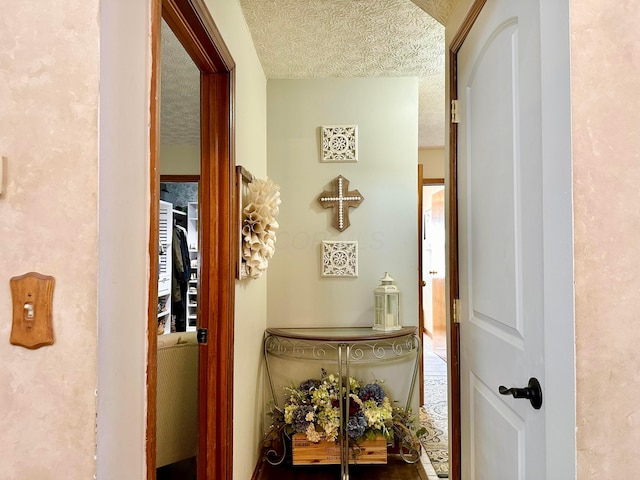 hallway featuring a textured ceiling