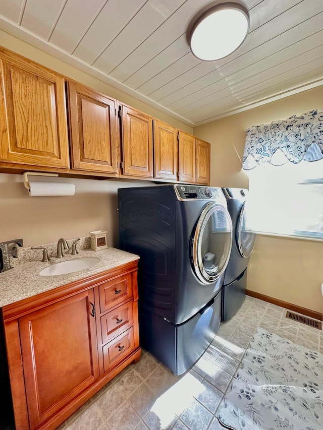 washroom with cabinet space, visible vents, wood ceiling, independent washer and dryer, and a sink