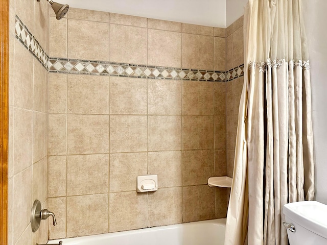 bathroom featuring toilet and shower / tub combo