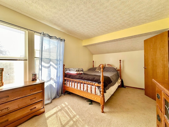 bedroom featuring lofted ceiling, a textured ceiling, baseboards, and light colored carpet