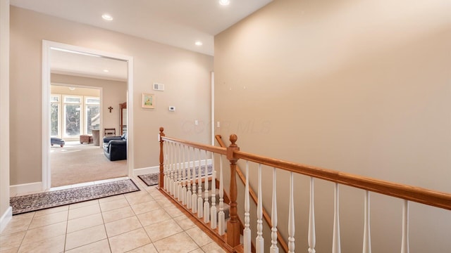 hall with baseboards, light colored carpet, light tile patterned floors, an upstairs landing, and recessed lighting