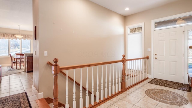 foyer entrance with light tile patterned flooring, recessed lighting, and baseboards