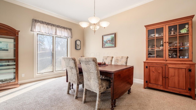 dining area featuring a chandelier, light carpet, baseboards, and ornamental molding