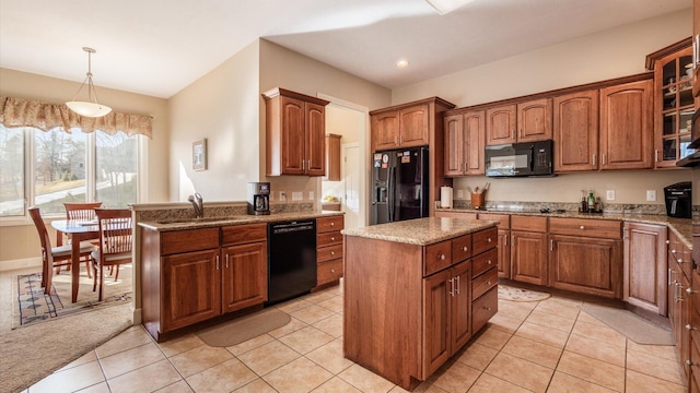 kitchen featuring black appliances, a sink, a center island, light tile patterned flooring, and glass insert cabinets