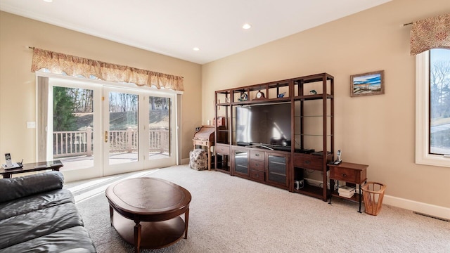 carpeted living area with recessed lighting, visible vents, and baseboards