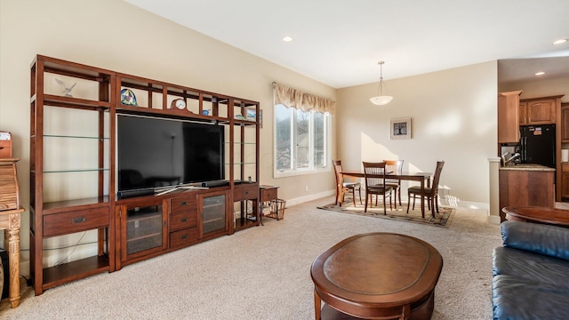 carpeted living area with recessed lighting and baseboards