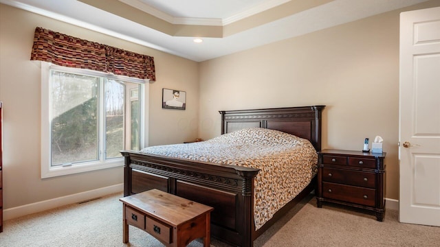 bedroom featuring a tray ceiling, multiple windows, baseboards, and light carpet