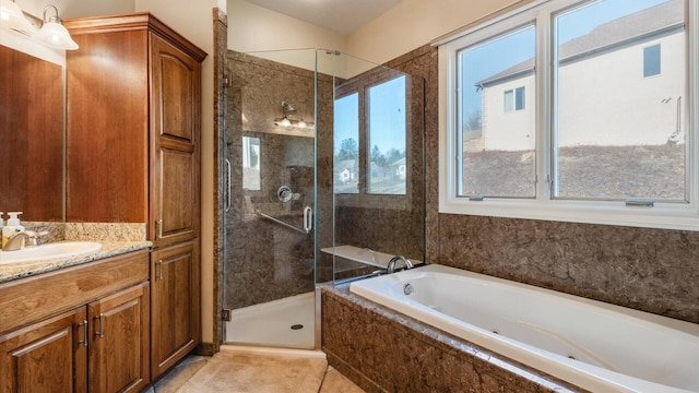 full bathroom with a bath, a shower stall, tile patterned floors, and vanity