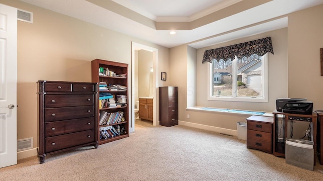 office with a tray ceiling, baseboards, light colored carpet, and visible vents