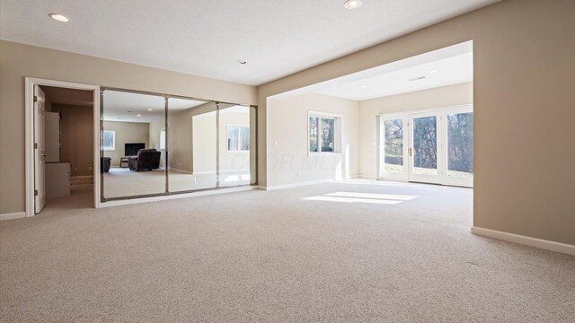 unfurnished bedroom with recessed lighting, carpet, and baseboards