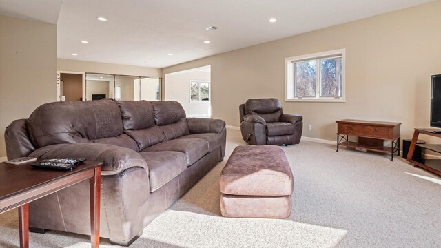living area featuring light carpet, visible vents, recessed lighting, and baseboards