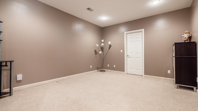 interior space featuring light colored carpet, recessed lighting, baseboards, and visible vents