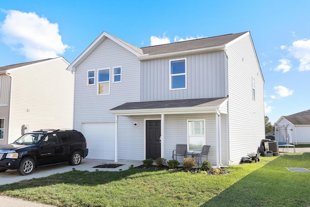 traditional home featuring driveway, an attached garage, board and batten siding, and a front yard