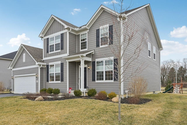 view of front of house featuring a garage, driveway, board and batten siding, and a front yard