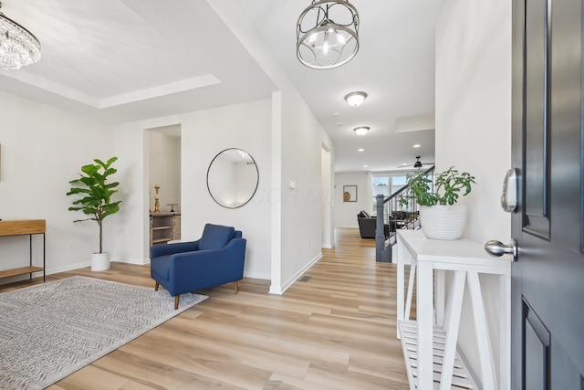 entrance foyer featuring stairs, recessed lighting, light wood-style flooring, baseboards, and ceiling fan with notable chandelier