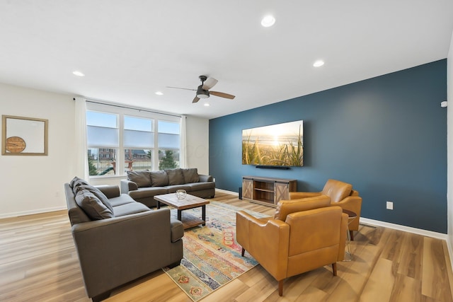 living room featuring light wood-style flooring, baseboards, and recessed lighting