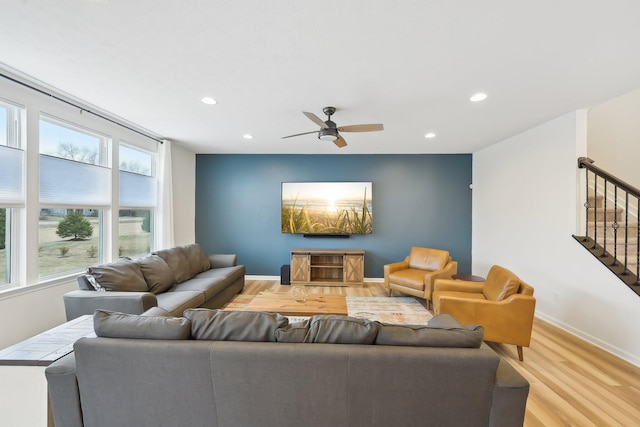 living area featuring light wood finished floors, stairway, recessed lighting, and baseboards