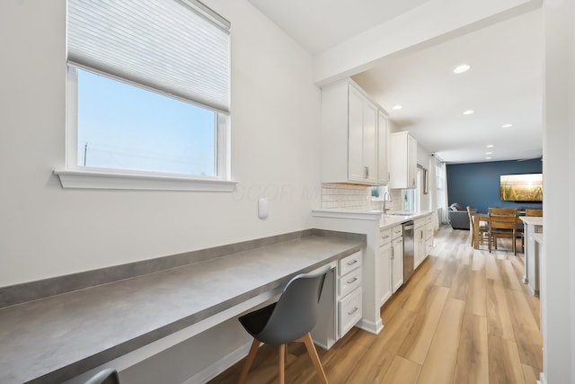 home office with light wood finished floors, a sink, and recessed lighting