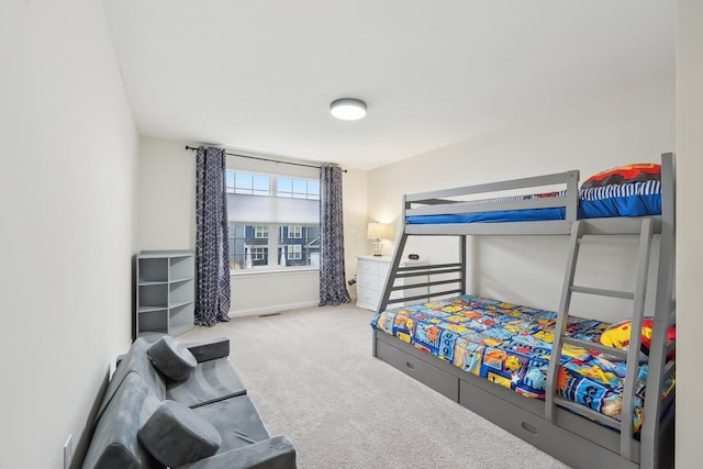 carpeted bedroom with visible vents and baseboards