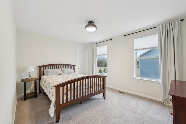 carpeted bedroom with baseboards and visible vents